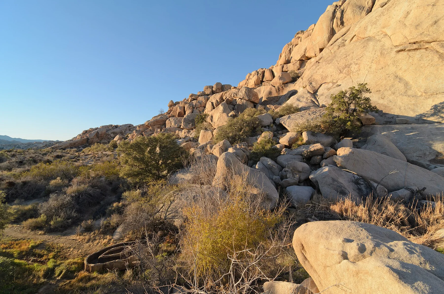 Barker Dam reservoir bordered by rock formations and desert vegetation
