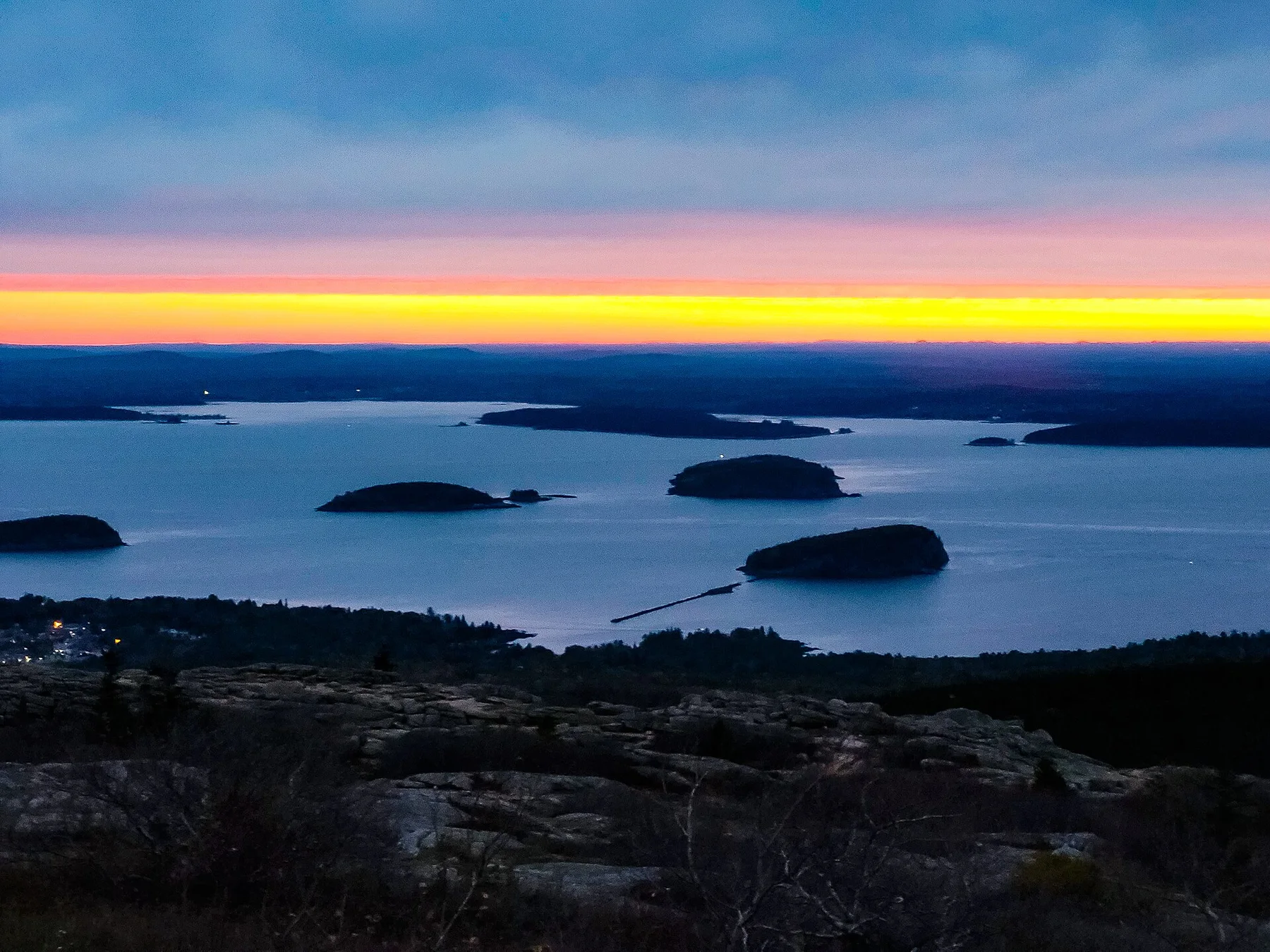 Sunrise light over islands and ocean from Cadillac Mountain